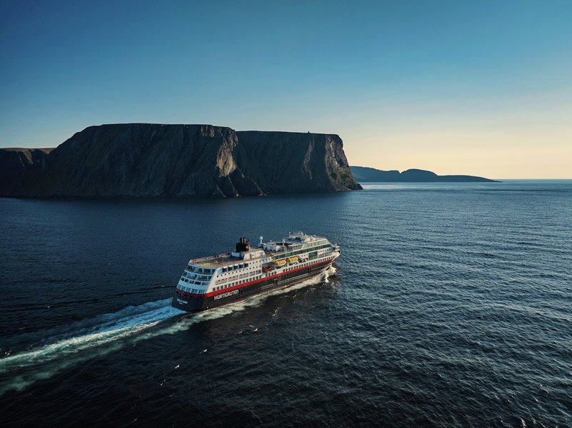 One of Hurtigruten's ships sailing through the Geirangerfjord