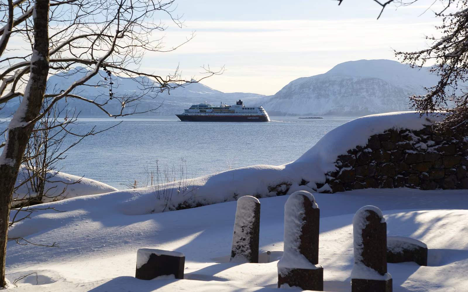 A Hurtigruten ship on the snowy coast near Harstad
